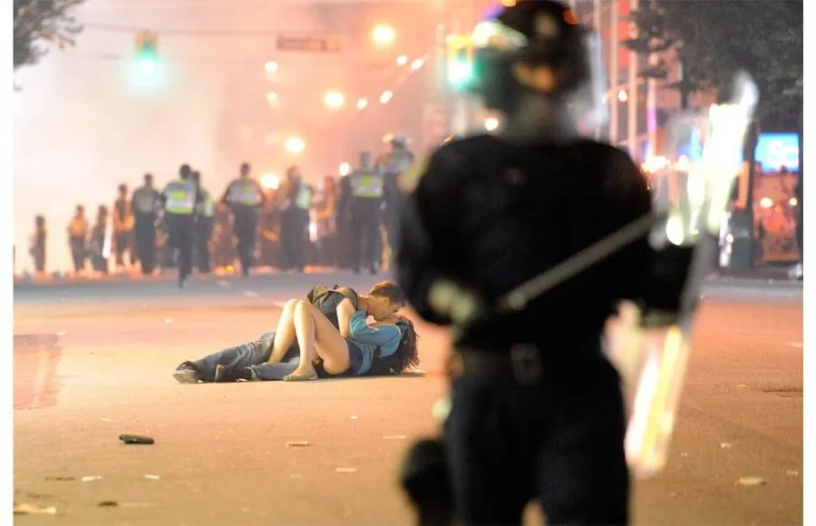 A Couple Kisses On A Street After Riots Broke Out In Vancouver, British Columbia | Rich Lam/Getty Images | 2011
